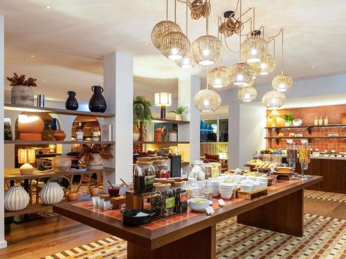a store filled with lots of dishes and vases at Novotel Luxembourg Kirchberg in Luxembourg