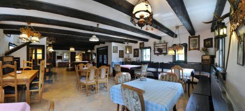 a restaurant with tables and chairs and a dining room at Casa Poveste Pensiunea-Muzeu in Câmpulung Moldovenesc