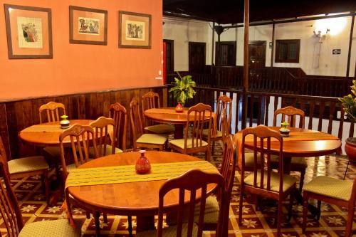 a restaurant with wooden tables and chairs in a room at Hotel Casablanca in Cajamarca