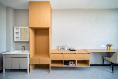 a bathroom with a sink and a wooden desk at Shanghai Rui deng hao Hotel-Free shuttle bus to Airport and Disneyland 24x7 in Shanghai