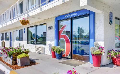 a store front with potted plants in front of it at Motel 6-Medford, OR in Medford