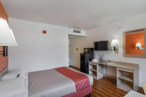 a hotel room with a bed and a desk at Motel 6-Medford, OR in Medford