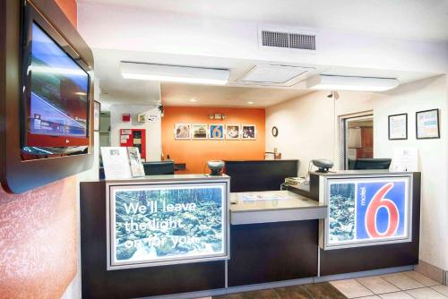 a fast food restaurant with a counter with a sign at Motel 6-Mammoth Lakes, CA in Mammoth Lakes