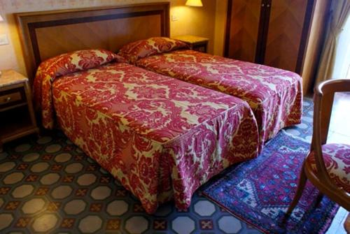 En eller flere senge i et værelse på Hotel Progresso