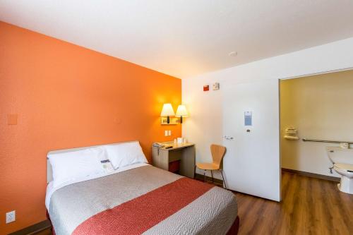 a hotel room with a bed and a bathroom at Motel 6-Klamath Falls, OR in Klamath Falls