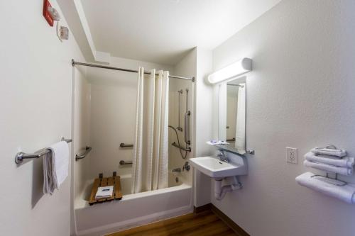 a white bathroom with a shower and a sink at Motel 6-Klamath Falls, OR in Klamath Falls