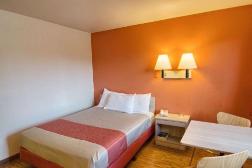 a hotel room with a bed and a small table at Motel 6-Coeur D'Alene, ID in Coeur d'Alene