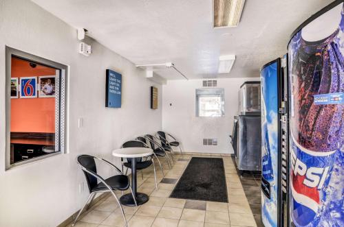 a room with chairs and a table in a room at Motel 6 Fort Collins, CO in Fort Collins