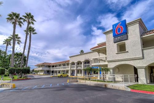 a hotel with a sign on the side of it at Motel 6-Carlsbad, CA Beach in Carlsbad