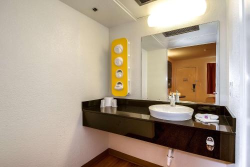 a bathroom with a sink and a mirror at Motel 6-Carlsbad, CA Beach in Carlsbad