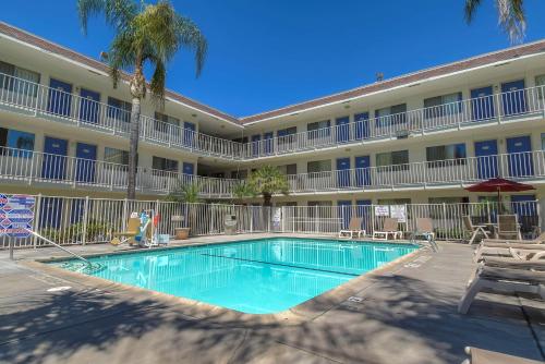a swimming pool in front of a hotel at Motel 6-San Bernardino, CA - North in Serrano Village