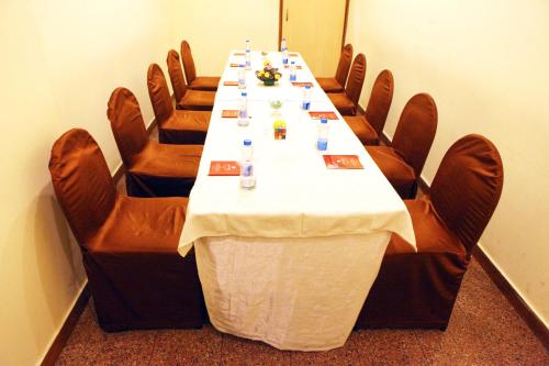 a conference room with a long table and chairs at Lords Plaza Surat in Surat