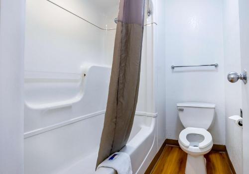 a small bathroom with a toilet and a shower at Motel 6 Mesa North in Mesa
