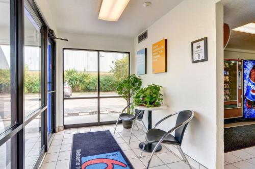 a room with a table and chairs and a window at Motel 6-Pittsburgh, PA - Crafton in Pittsburgh