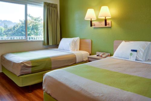 a hotel room with two beds and a window at Motel 6-Springfield, OR - Eugene North in Springfield