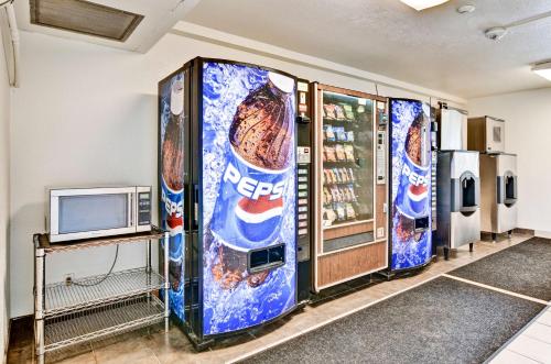 a pair of pepsi vending machines in a store at Motel 6-Pittsburgh, PA - Crafton in Pittsburgh
