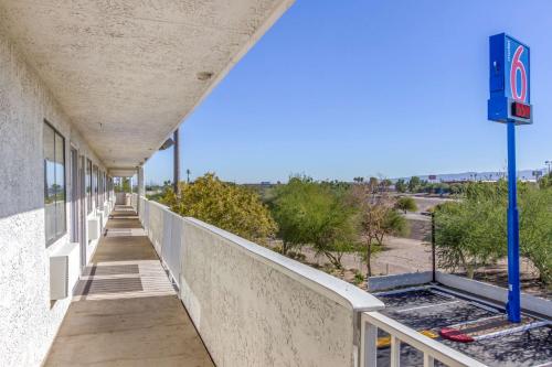 an empty corridor of a building with a sign on the side at Motel 6-Phoenix, AZ - West in Phoenix
