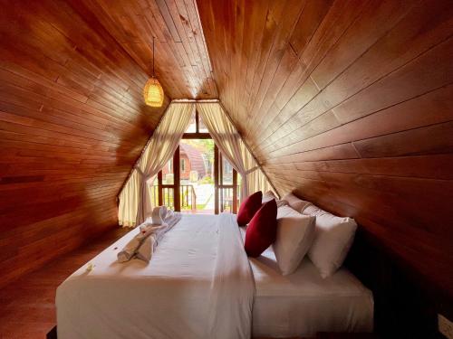 a bedroom with a large bed with a window at Dalung Tropical in Dalung