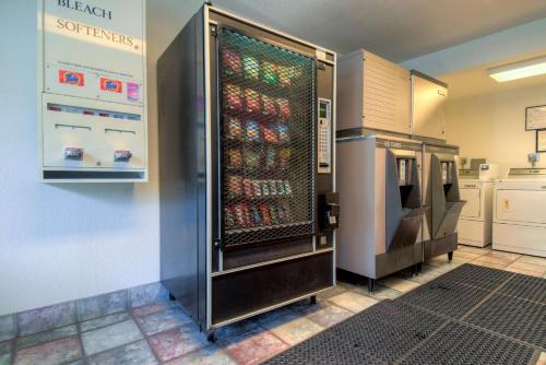 a refrigerator filled with lots of bottles of soda at Motel 6-Santa Ana, CA in Santa Ana