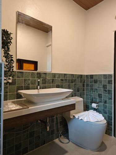 a bathroom with a sink and a toilet at Tangerine Villa Patong in Patong Beach