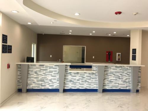 a lobby with a counter with a large mirror at Americas Best Value Inn & Suites Spring / N. Houston in Spring