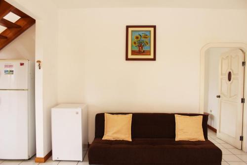 a living room with a couch and a refrigerator at The Finch House (La Casa del Pinzón) in Puerto Ayora