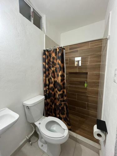 a bathroom with a toilet and a shower at Noir Beach Suite in Ciudad Madero