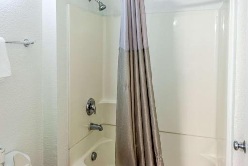 a bathroom with a shower with a shower curtain at Motel 6-Bakersfield, CA - East in Bakersfield