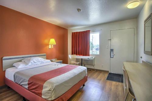 a hotel room with a bed and a desk and a window at Motel 6-New Cumberland, PA - Harrisburg - Hershey South in New Cumberland