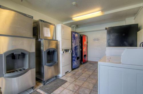 a kitchen with stainless steel refrigerators and a counter at Motel 6-Orlando, FL - Winter Park in Orlando