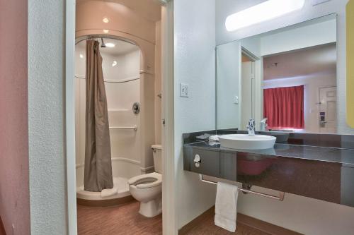 a bathroom with a sink and a toilet and a mirror at Motel 6-Flagstaff, AZ - West - Woodland Village in Flagstaff