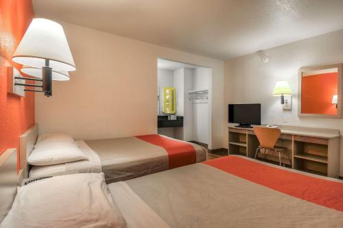 a hotel room with two beds and a desk at Motel 6-Chino, CA - Los Angeles Area in Chino