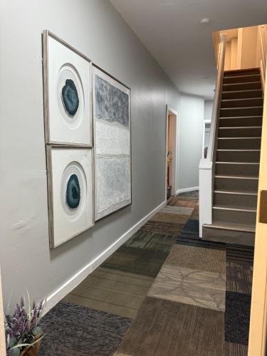 a hallway with two paintings on a wall and stairs at Eagle Pamir Guest House in New Haven