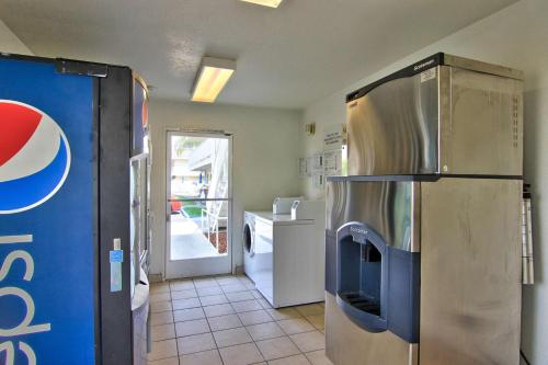a kitchen with a stainless steel refrigerator in a room at Motel 6-Sacramento, CA - South Sacramento and Elk Grove in Sacramento