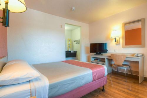 a hotel room with two beds and a desk at Motel 6-El Cajon, CA - San Diego in El Cajon