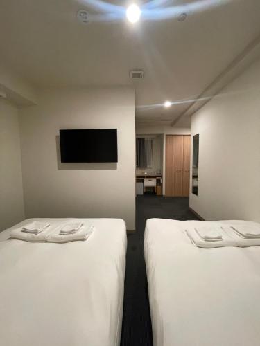 Postel nebo postele na pokoji v ubytování Hopetree OSAKA GRAND