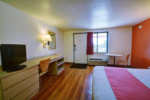 a hotel room with a bed and a flat screen tv at Motel 6-Chicopee, MA - Springfield in Chicopee