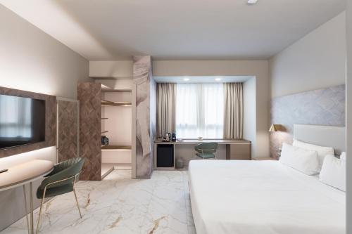 a bedroom with a large white bed and a desk at Baires Guest House in Milan