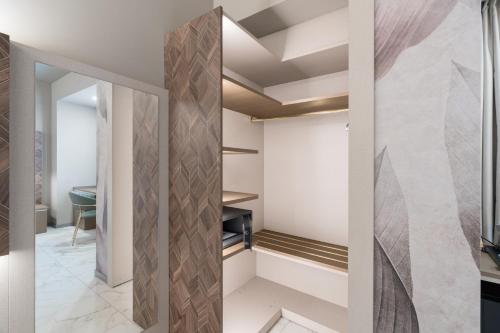a walk in closet with a glass door at Baires Guest House in Milan