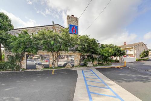 a building with a parking lot in front of it at Motel 6-San Antonio, TX - Northwest Medical Center in San Antonio