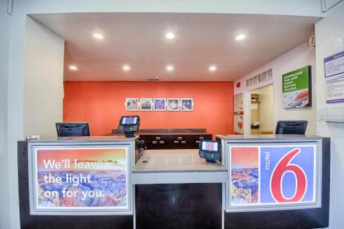 a waiting room with two signs on a counter at Motel 6-San Antonio, TX - Northwest Medical Center in San Antonio
