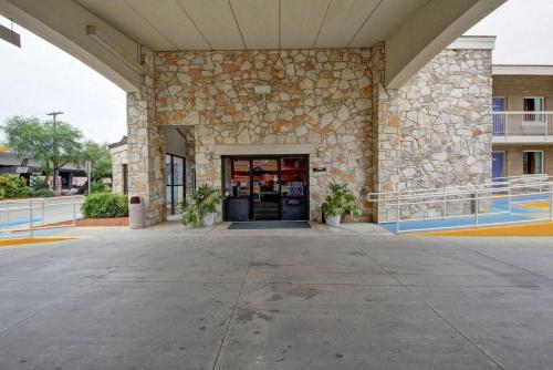 a front door of a building with a stone wall at Motel 6-San Antonio, TX - Downtown - Market Square in San Antonio