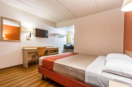 a hotel room with a bed and a desk at Motel 6 Tempe, AZ Phoenix Airport Priest Dr in Tempe