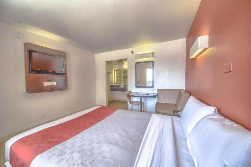 a hotel room with a bed and a desk at Motel 6 San Antonio, Tx Six Flags Fiesta TX - La Cantera Area in San Antonio