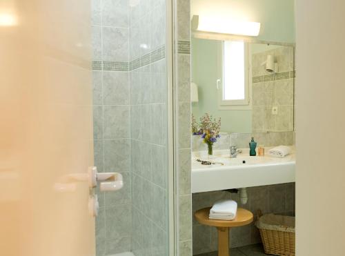 a bathroom with a shower and a sink at Logis Hotel Spa Restaurant Le Provence in Lanarce