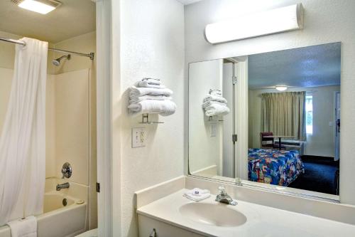 a bathroom with a sink and a mirror at Knights Inn Burlington NC in Burlington