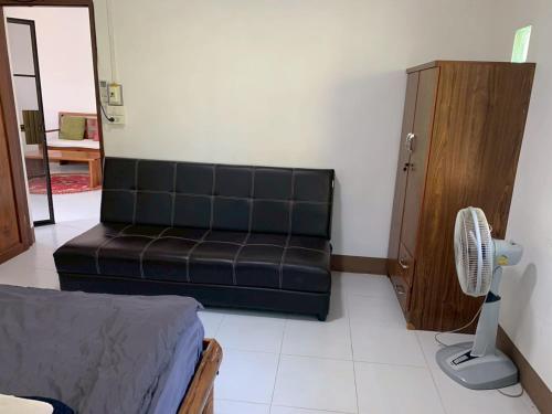 un soggiorno con divano e ventilatore di 2BR Local House Abode a Pai