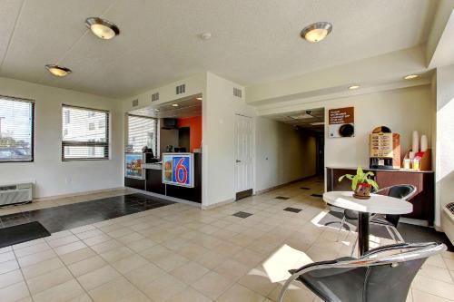 a living room with a table and a kitchen at Motel 6-York, PA - North in York