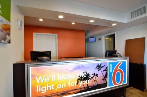 a television in a room with a sign on it at Motel 6-North Palm Springs, CA - North in North Palm Springs