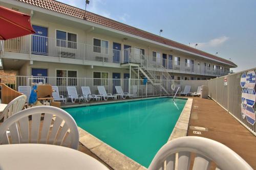a swimming pool in front of a hotel at Motel 6-Sacramento, CA - Old Sacramento North in Sacramento